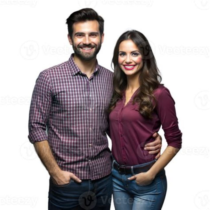 a man and woman standing next to each other in front of a truck on the