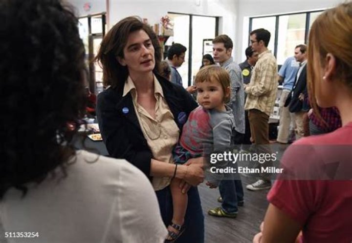 Actress Gaby Hoffmann holds her daughter Rosemary Dapkins as she