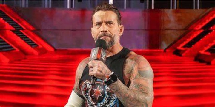 cm punk holding his hand to his ear, hulk hogan-style