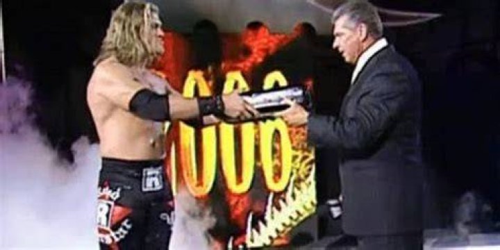Edge Handing Vince McMahon The MITB Briefcase