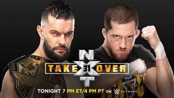 Finn Balor holding Kyle O'Reilly in arm bar in ring