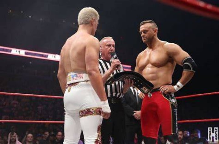 Nick Aldis and Cody Rhodes in a figure-four leglock. 
