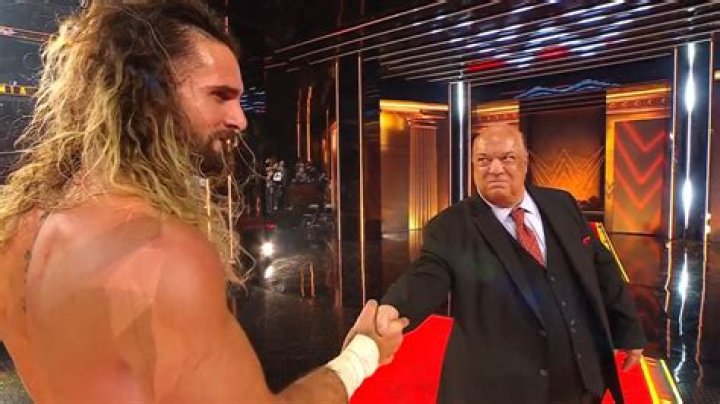 Paul Heyman shaking hands with AJ Styles