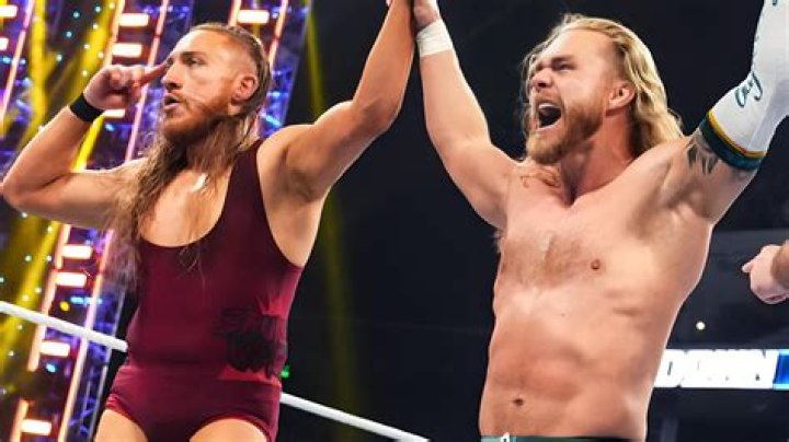 Pete Dunne holding Tyler Bate in a leg lock 
