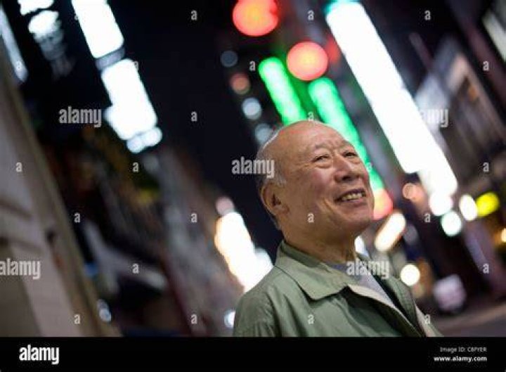Porn star Shigeo Tokuda, 77, poses for a photo outside a small cinema
