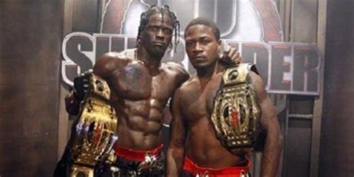 Ron Killings and Adam "Pacman" Jones posing with the TNA World Tag Team Championship