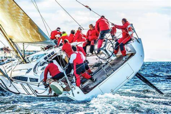 Sailing Crew On Sailboat During Regatta by Mbbirdy