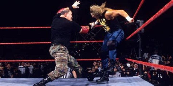 Sgt. Slaughter locking Triple H in the Cobra Clutch during their Boot Camp match
