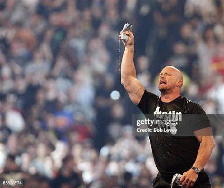 Stone Cold salutes the crowd with beer.