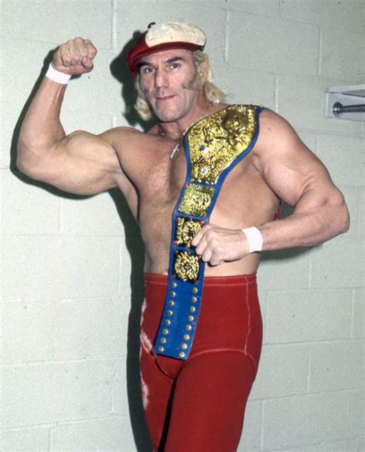 Superstar Billy Graham flexing with the WWE Championship