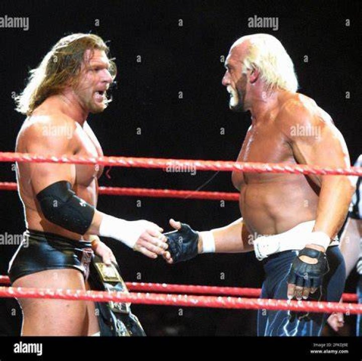 Triple H and Hulk Hogan facing off in the ring